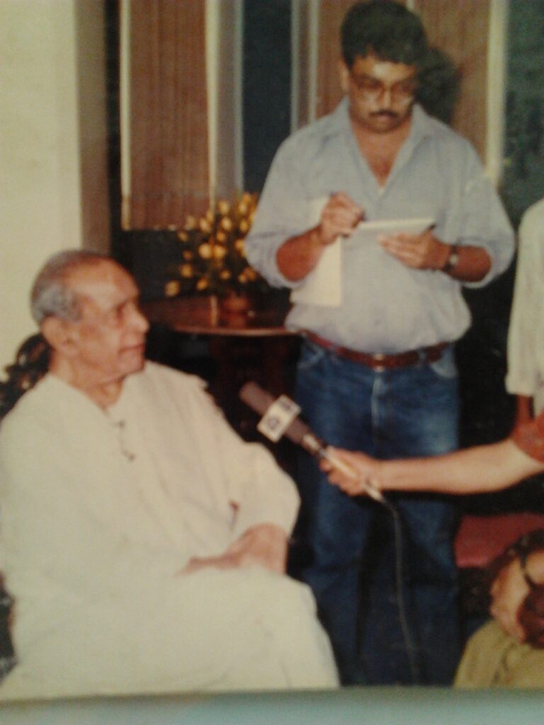 The author taking notes as the maestro speaks in Mumbai, for the launch of the six-cassette series to mark his 75th birthday in 1997