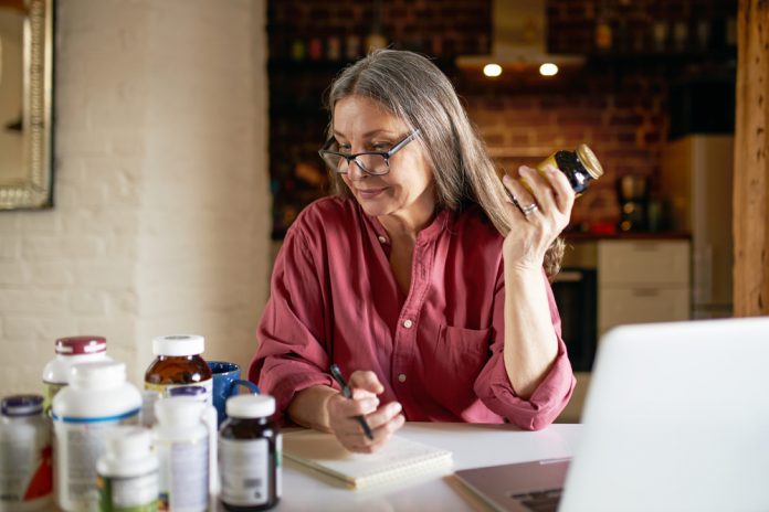 Portrait,Of,Middle,Aged,Female,Nutritionist,In,Eyeglasses,Making,Research,