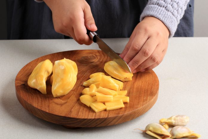 Selected,Focus,Female,Asian,Hand,Slicing,Yellow,Ripe,Jackfruit.,Concept