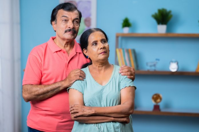 Indian,Thoughtful,Senior,Couple,Looking,Away,From,Camera,By,Standing