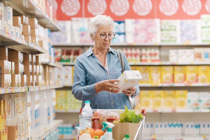Senior,Woman,Doing,Grocery,Shopping,,She,Is,Reading,Information,On