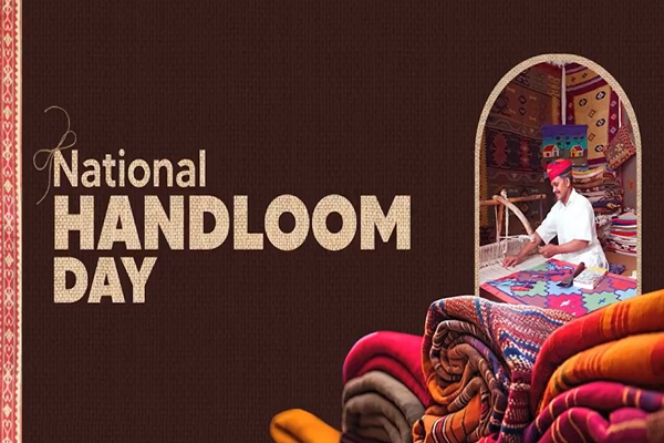 HAND Poster for National Handloom Day showing a craftsman weaving fabric beside a pile of colorful textiles in the foreground.
