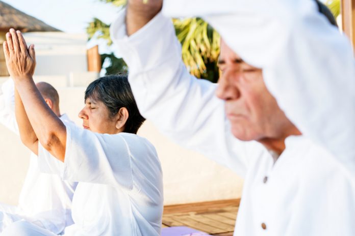 Group,Of,Seniors,Practicing,Yoga,In,The,Morning